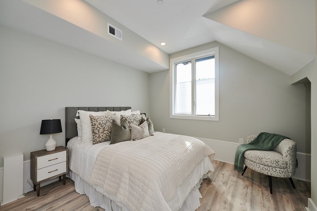 96 Cottage Street, Unit PARLOR Boston, MA 02128 - Photo 6 of 15 a bedroom with a bed and a couch