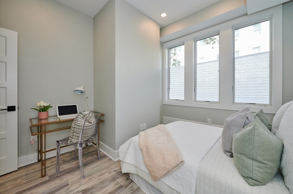 96 Cottage Street, Unit PARLOR Boston, MA 02128 - Photo 8 of 15 a bedroom with a bed and a window