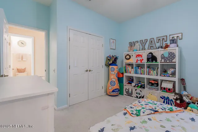 a living room with furniture flat screen tv and kitchen view