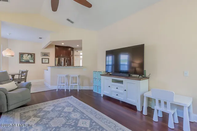 a white toilet sitting next to a white wall