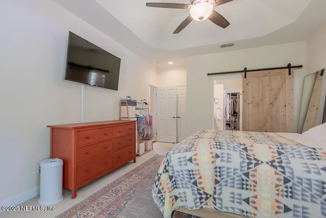 a en suite bathroom with a double vanity sink and a mirror