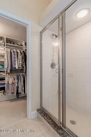 a bedroom with a bed furniture and a flat tv screen