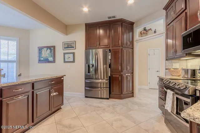 a kitchen with granite countertop cabinets sink and window