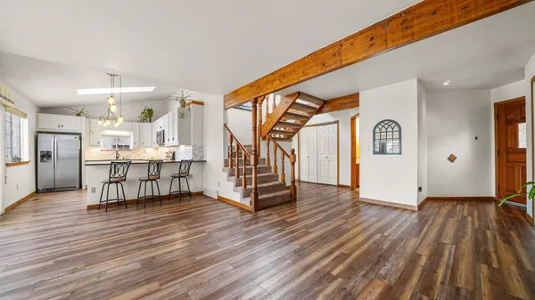 a view of an entryway with wooden floor