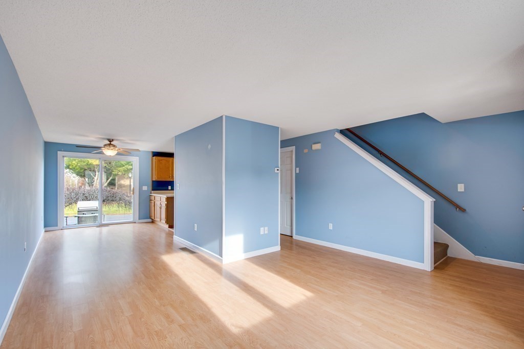 55 Littleton Road, Unit 29E Ayer, MA 01432 - Photo 8 of 20 a view of a big room with wooden floor and windows
