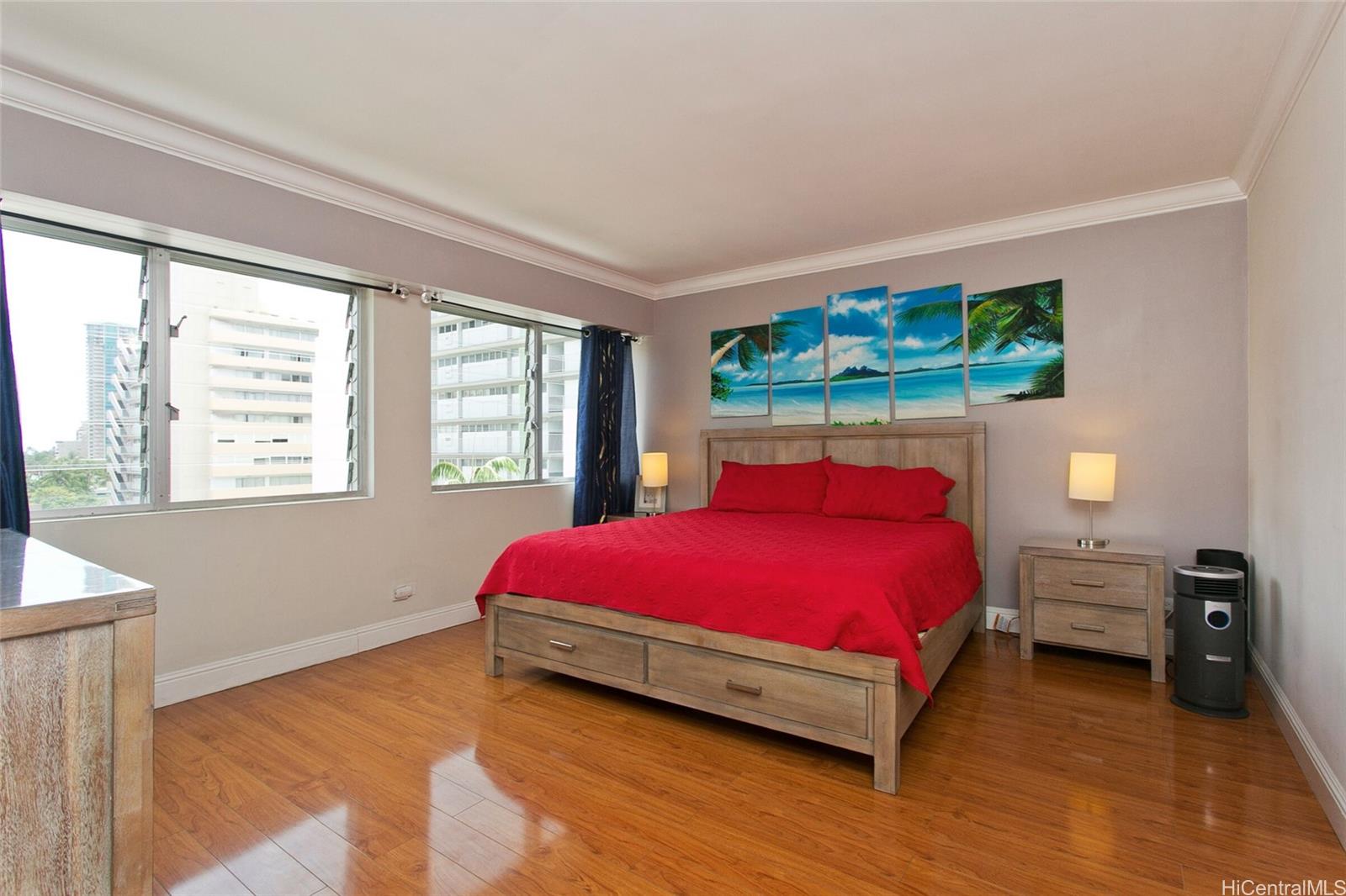 2015 Ala Wai Boulevard, Unit 8A Honolulu, HI 96815 - Photo 12 of 18 a bed sitting in a bedroom next to a window