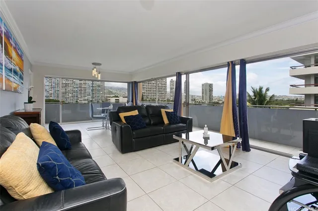 a living room with furniture and a floor to ceiling window