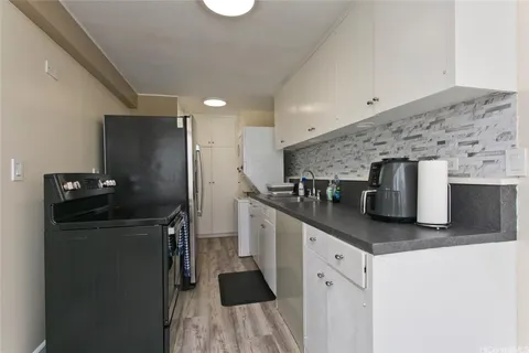 a kitchen with stainless steel appliances granite countertop a sink and a refrigerator