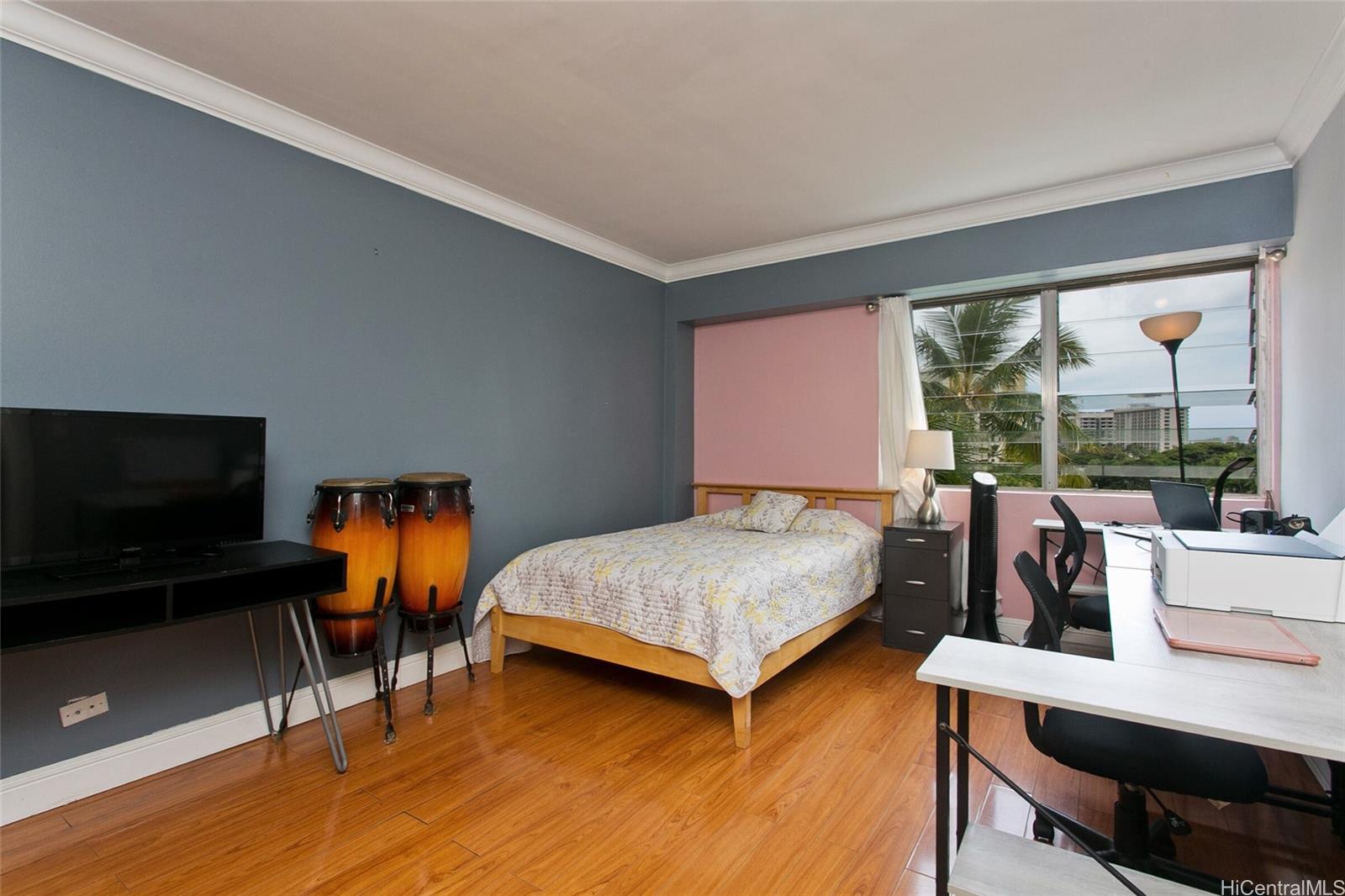 2015 Ala Wai Boulevard, Unit 8A Honolulu, HI 96815 - Photo 10 of 18 a bedroom with furniture and a flat screen tv