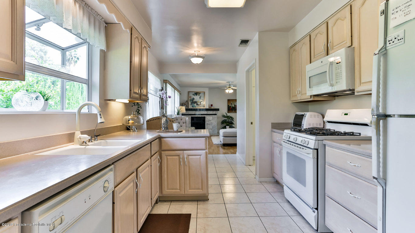 3810 Fairmeade Road Pasadena, CA 91107 - Photo 11 of 47 a kitchen with a sink stove and cabinets