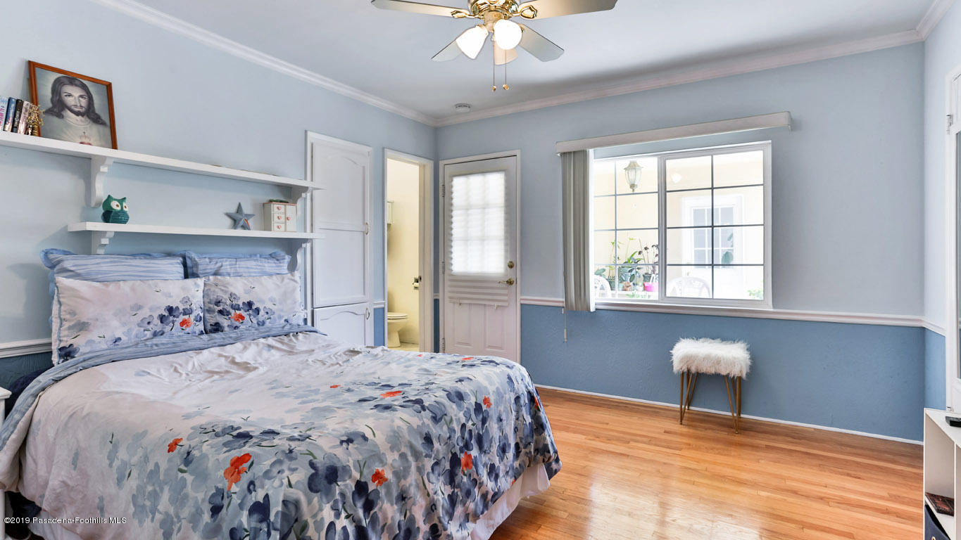 3810 Fairmeade Road Pasadena, CA 91107 - Photo 24 of 47 a bedroom with a bed and a chandelier