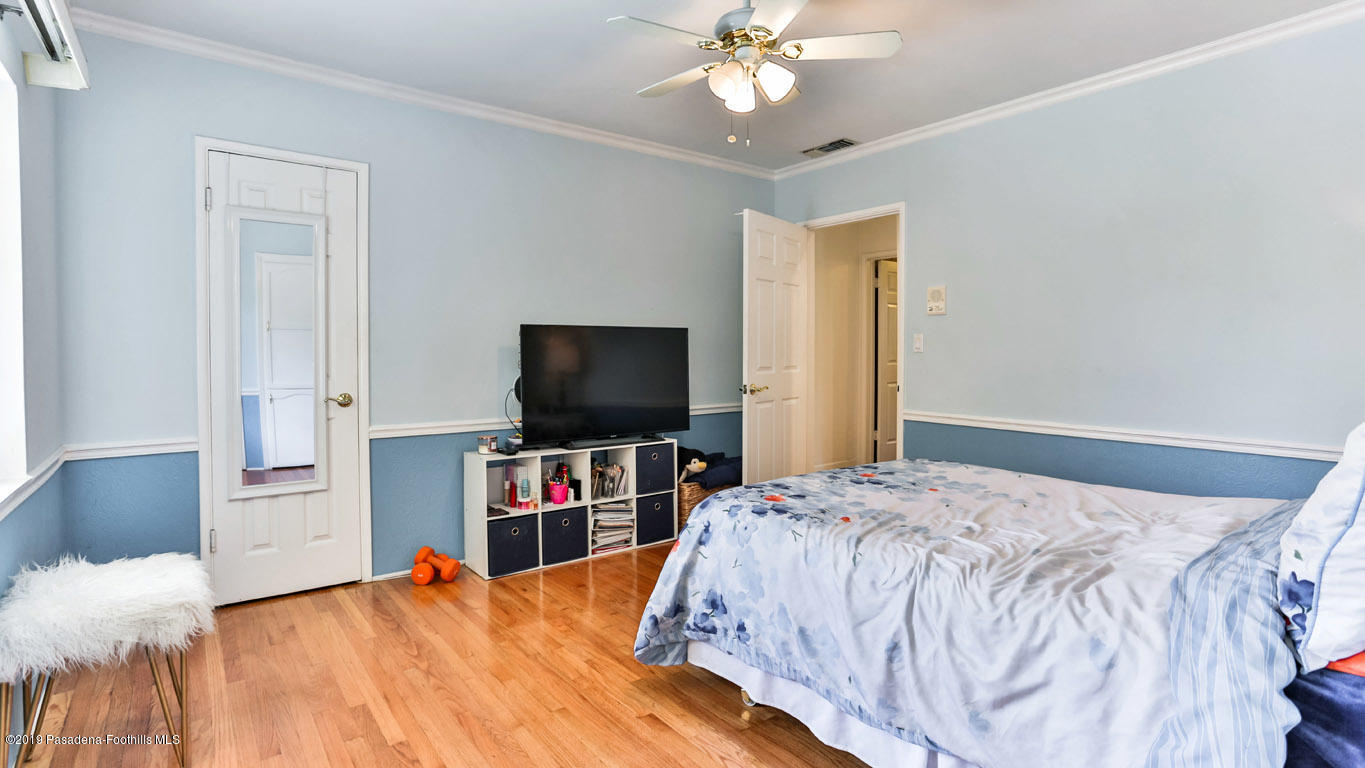 3810 Fairmeade Road Pasadena, CA 91107 - Photo 25 of 47 a bedroom with a bed and a flat tv screen on dresser