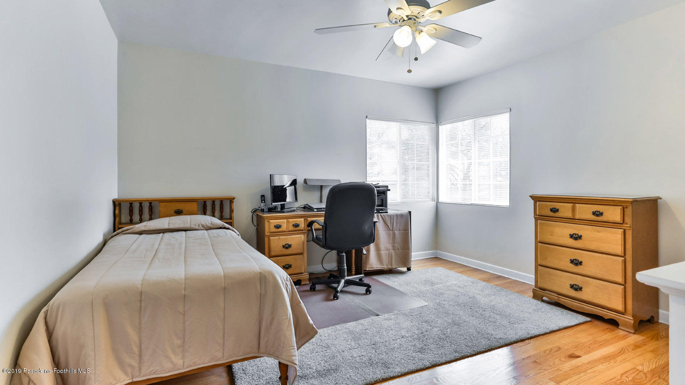 3810 Fairmeade Road Pasadena, CA 91107 - Photo 26 of 47 a bedroom with a bed and a chandelier