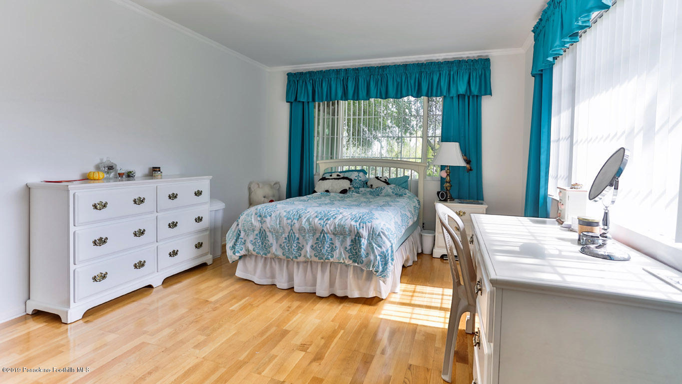 3810 Fairmeade Road Pasadena, CA 91107 - Photo 36 of 47 a bedroom with a bed and a dresser next to a window