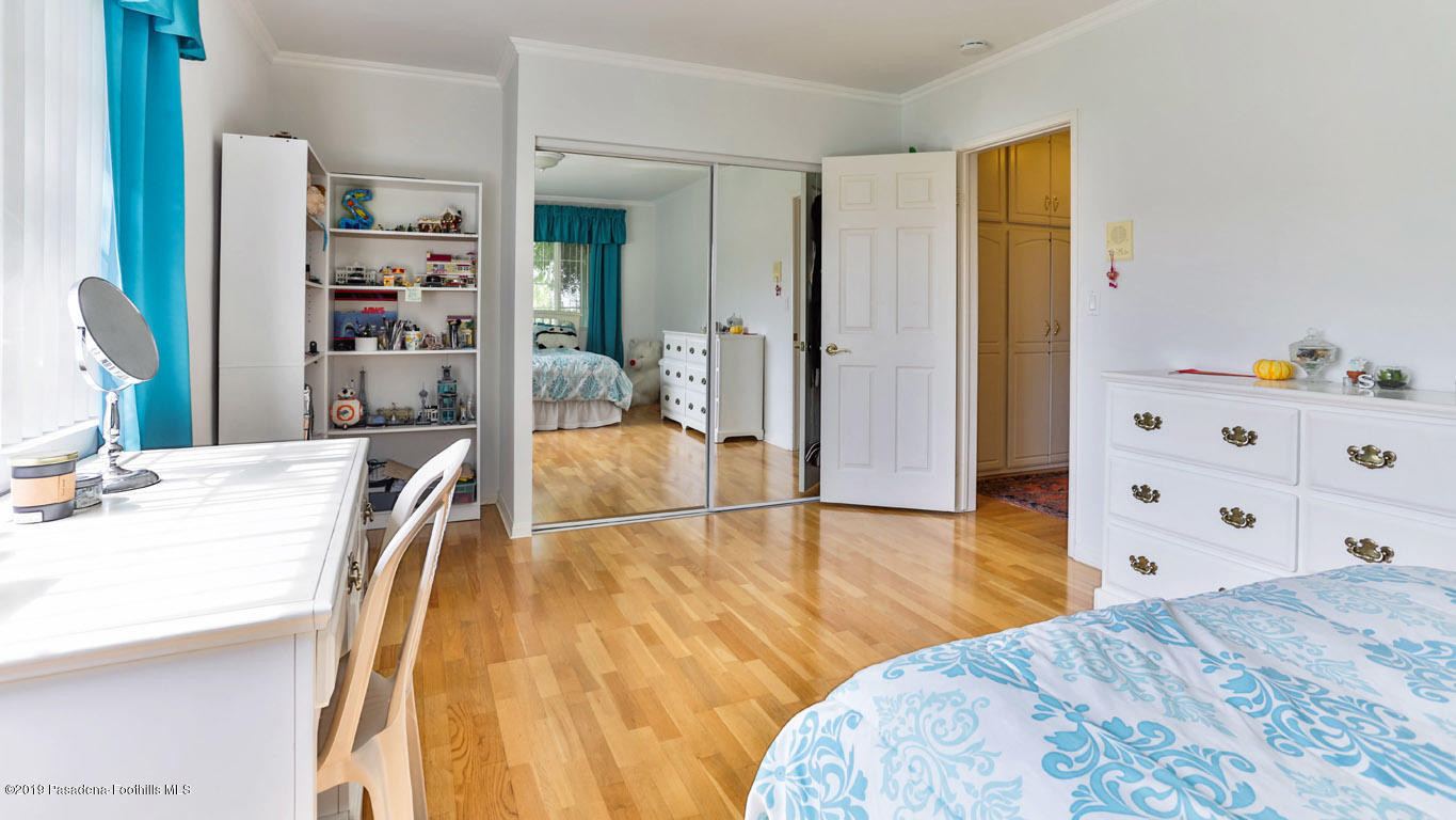 3810 Fairmeade Road Pasadena, CA 91107 - Photo 37 of 47 a spacious bedroom with a bed and a wooden floor