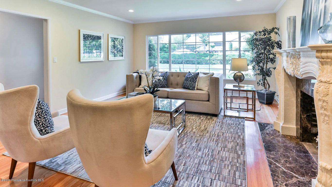 3810 Fairmeade Road Pasadena, CA 91107 - Photo 6 of 47 a living room with furniture a fireplace and a floor to ceiling window
