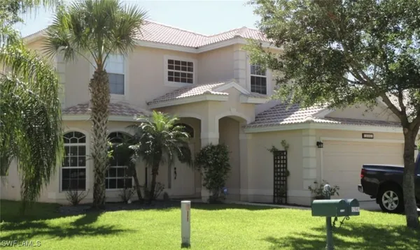 a view of a house with backyard porch and sitting area