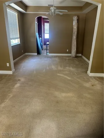 an empty room with closet and mirror