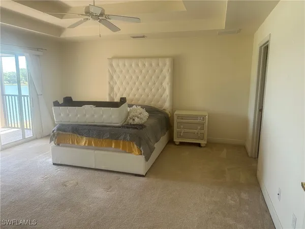 a bed sitting in a room next to a window