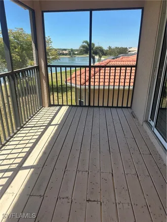 a view of balcony with wooden floor