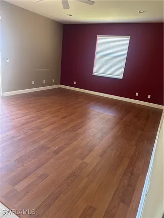 an empty room with wooden floor