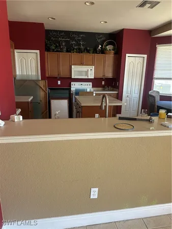 a view of a living room with kitchen furniture