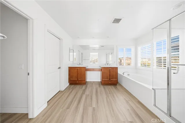 a large white kitchen with a white wooden cabinets and floors