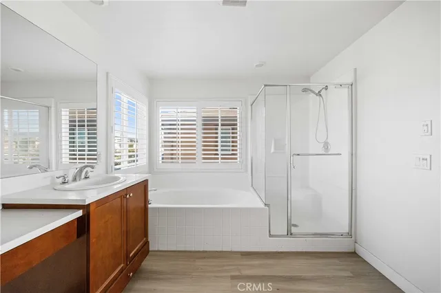 a bathroom with a tub a sink and a window