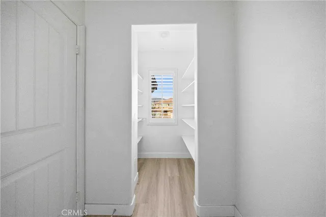 a view of hallway with wooden floor