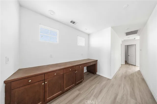 a view of a room with wooden floor