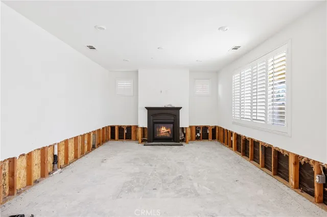 a view of an empty room with a fireplace