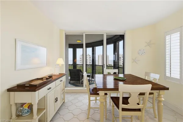 a kitchen with a table chairs refrigerator and cabinets