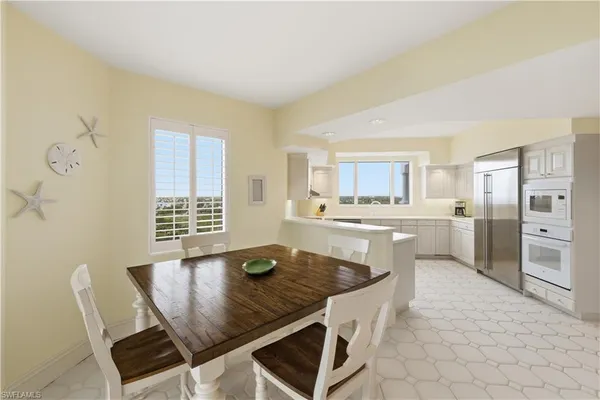 a bedroom with a large bed and a flat tv screen on dresser