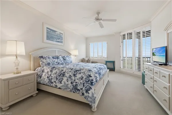 a bedroom with a bed and a night stand