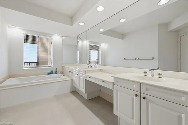 a bathroom with a sink double vanity and a shower