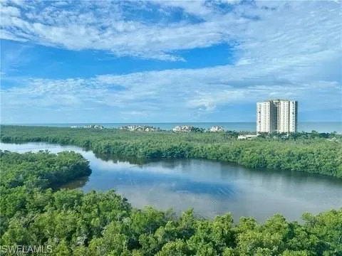 an aerial view of a house with a yard and lake view