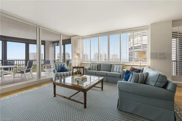 a living room with furniture and a large window