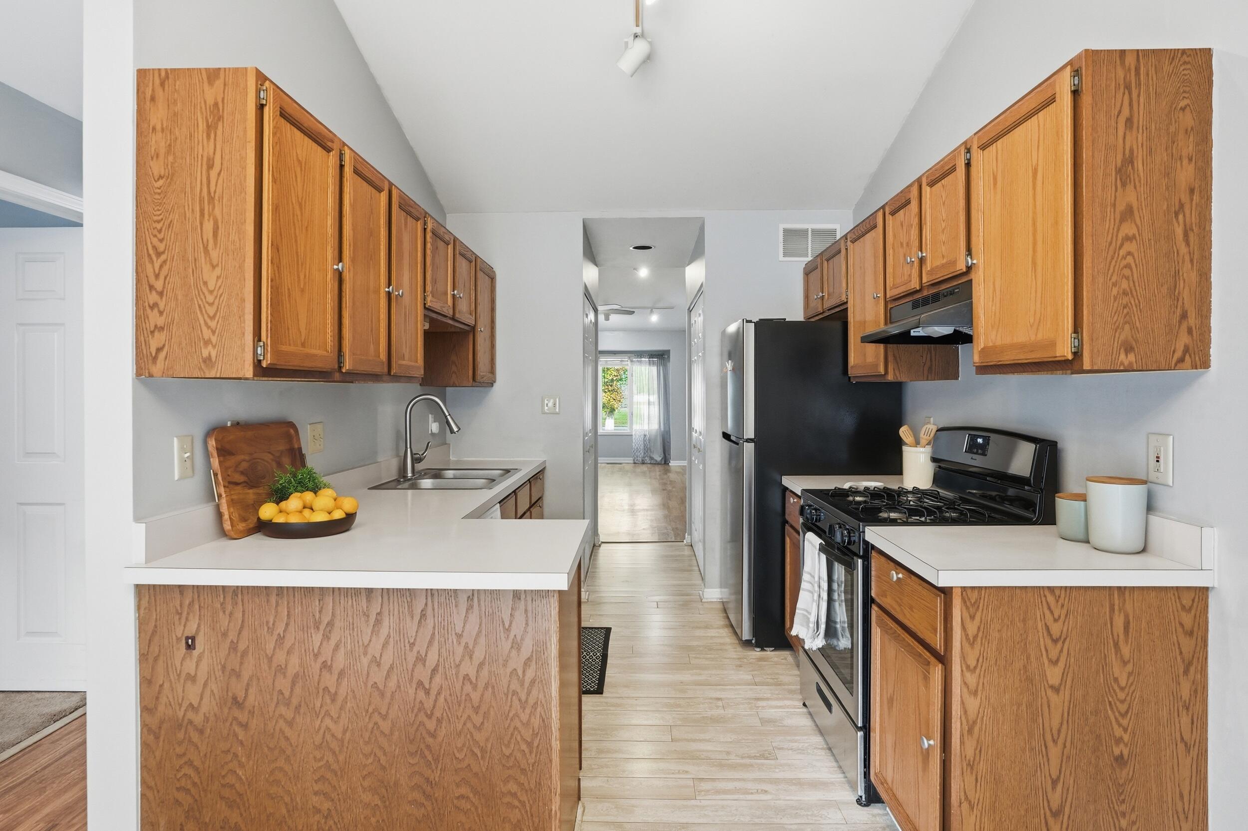 225 Clinton Street Lowell, IN 46356 - Photo 9 of 22 a kitchen with stainless steel appliances a stove a sink refrigerator and a cabinets