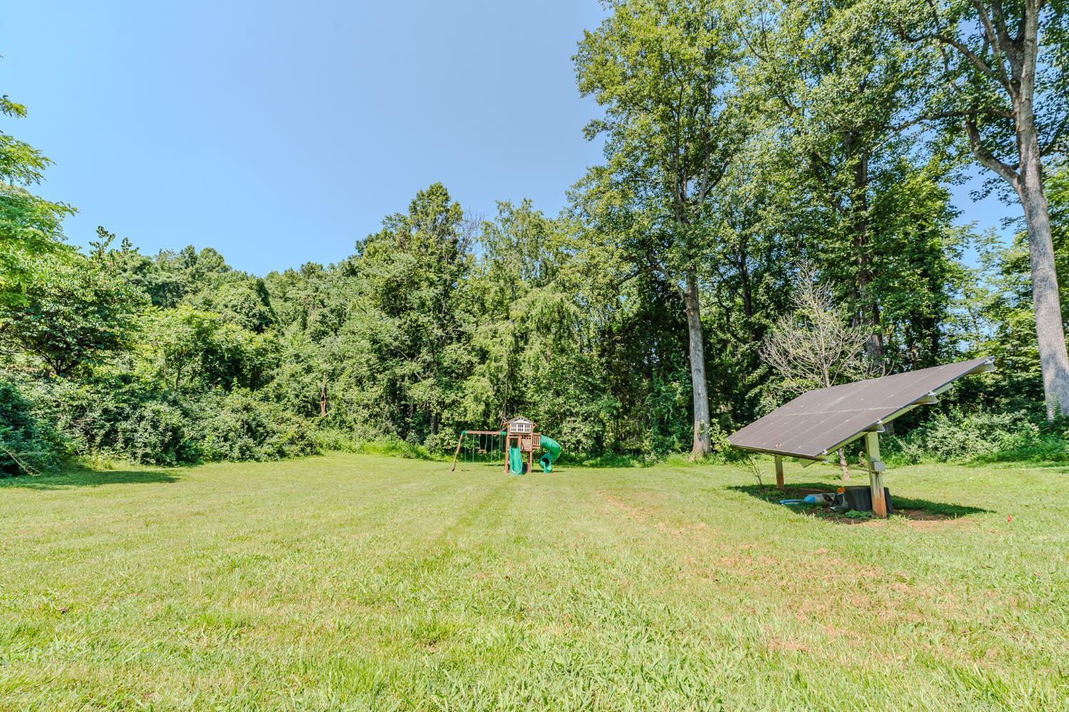 1553 Old Stage Road Amherst, VA 24521 - Photo 21 of 61 a view of a garden with a bench and plants