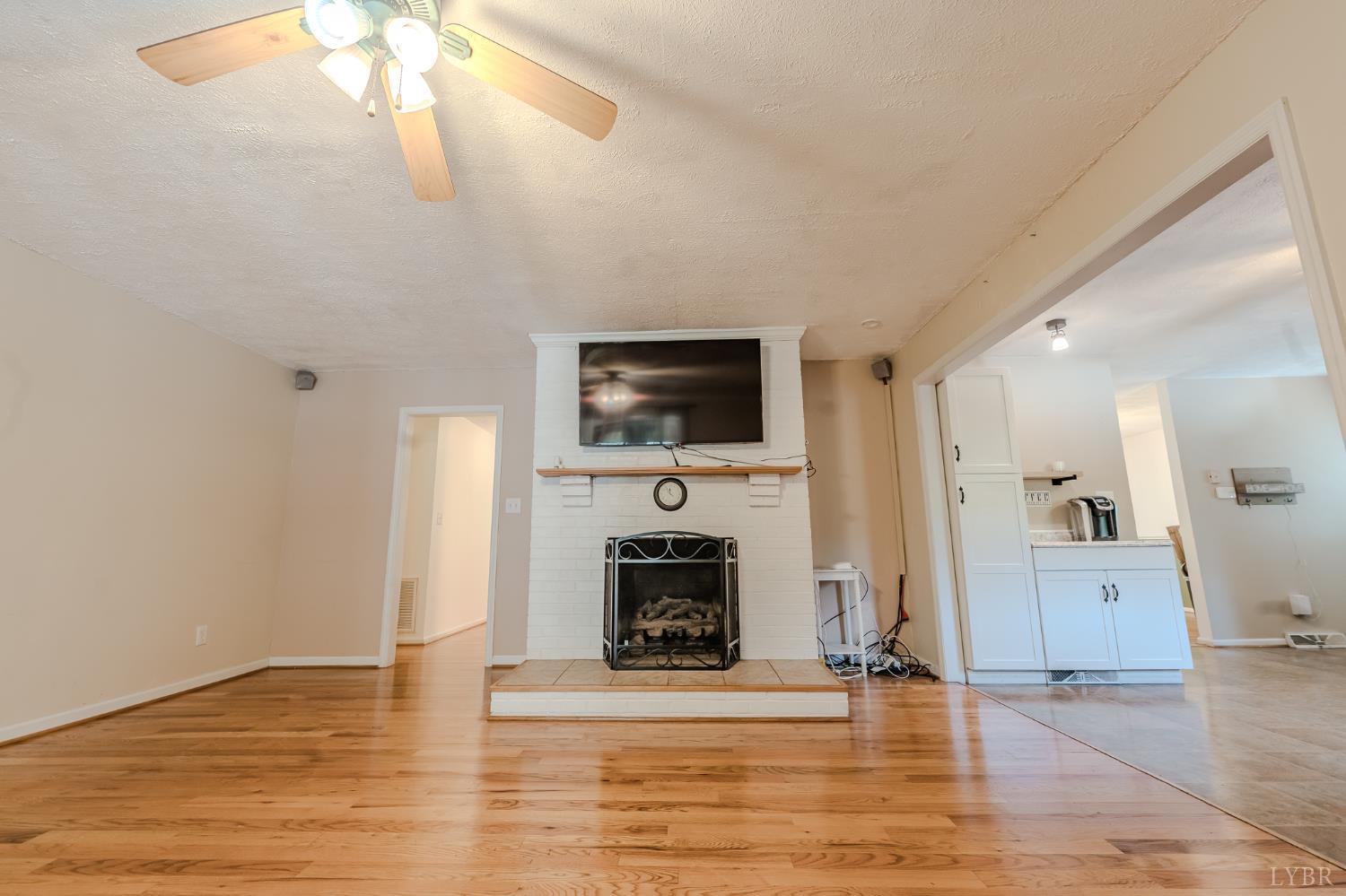 1553 Old Stage Road Amherst, VA 24521 - Photo 32 of 61 a living room with furniture a fireplace and a flat screen tv