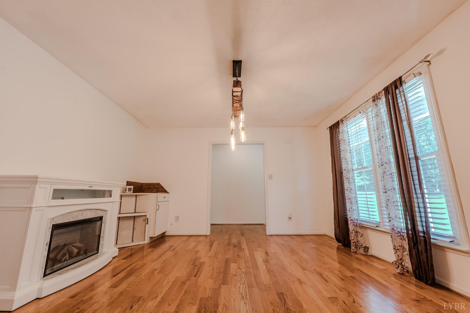 1553 Old Stage Road Amherst, VA 24521 - Photo 47 of 61 a view of empty room with wooden floor and fireplace
