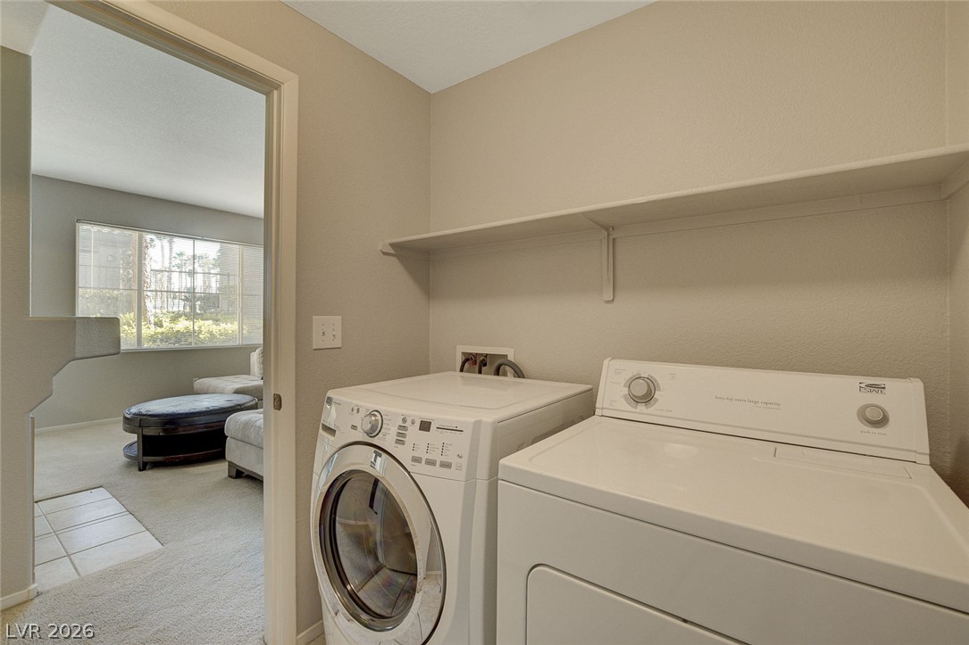9050 West Warm Springs Road, Unit 1034 Las Vegas, NV 89148 - Photo 12 of 17 Functional laundry room offers a convenient side-by-side washer and dryer with overhead shelving.