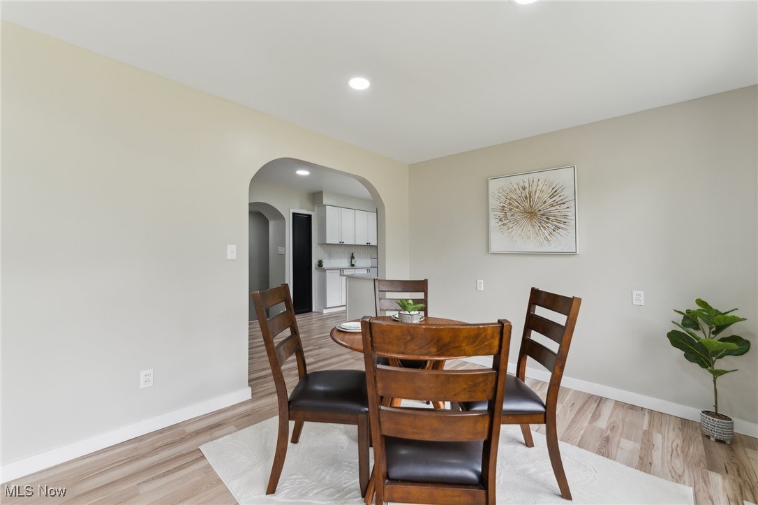 13225 Bagley Road Cleveland, OH 44130 - Photo 16 of 50 Dining room with arched walkways, light wood finished floors, baseboards, and recessed lighting