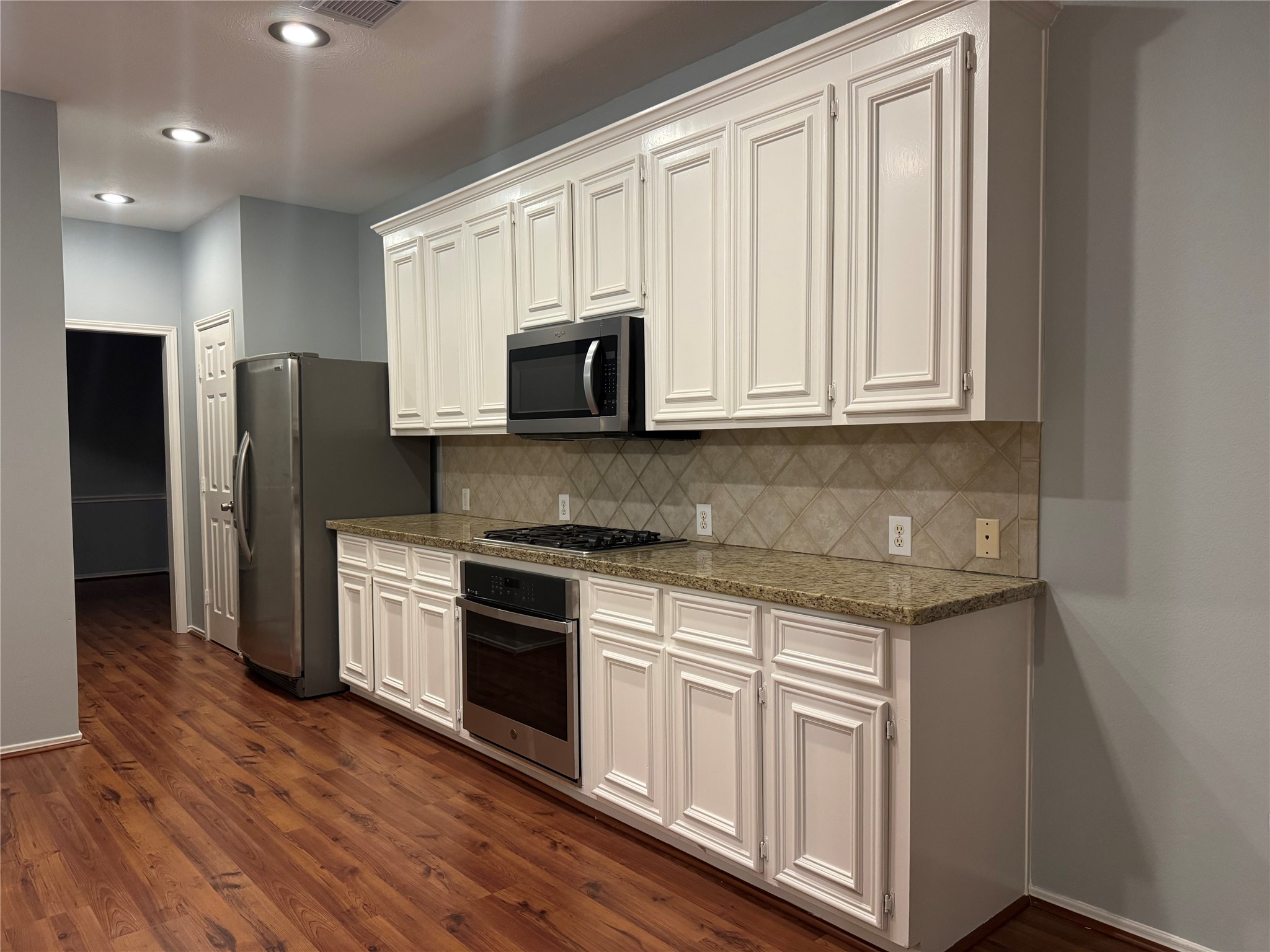 16210 Broken Timber Circle Houston, TX 77095 - Photo 10 of 28 Beautiful kitchen with granite countertops and white cabinetry!