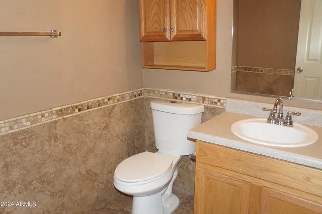 a bathroom with a sink a toilet and a mirror