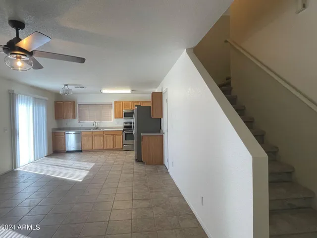 a kitchen with stainless steel appliances granite countertop a stove a sink and a refrigerator