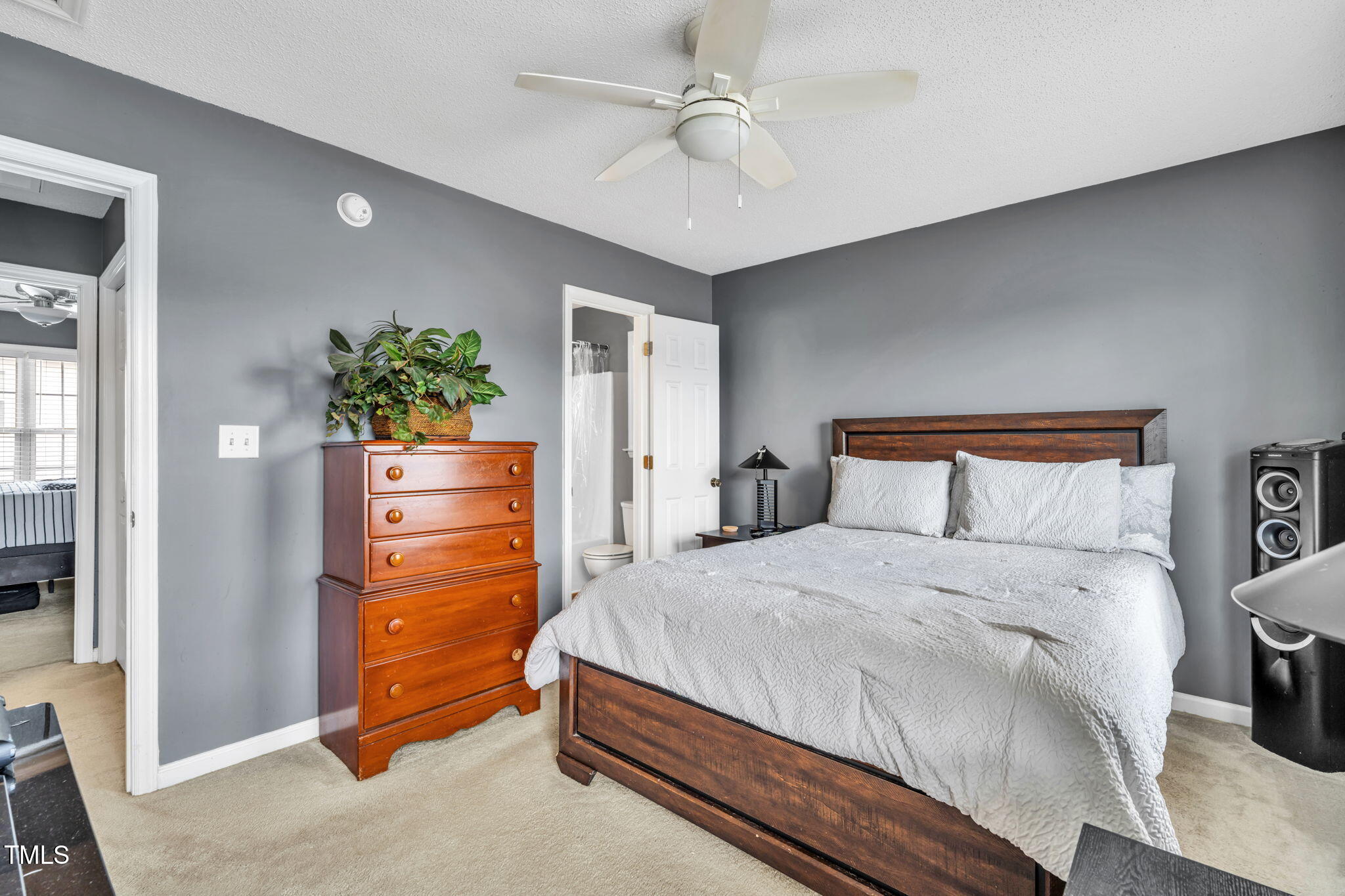 2203 Whistling Straits Way Raleigh, NC 27604 - Photo 16 of 31 a bedroom with a bed and a chandelier