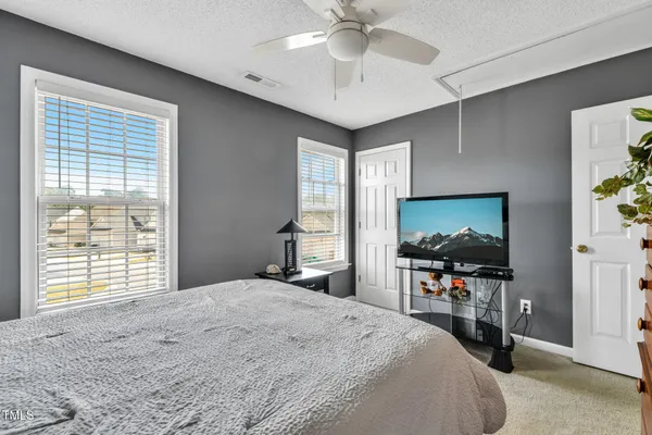 a bedroom with a bed and a flat screen tv