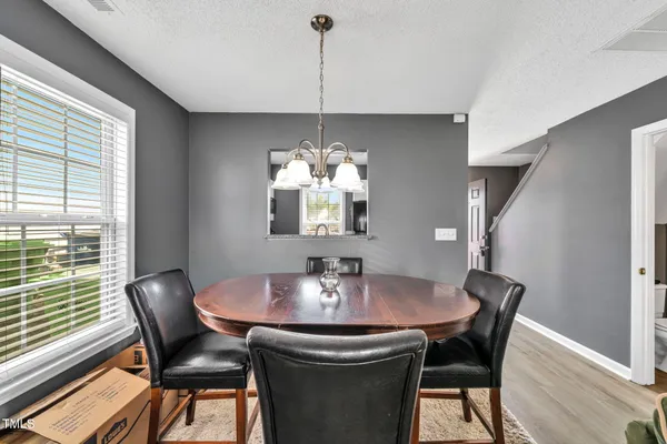 a dining room with furniture and window