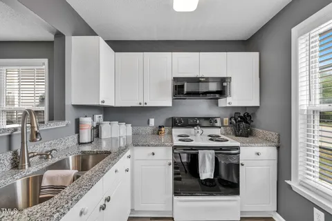 a kitchen with stainless steel appliances a stove a sink a stove and a microwave